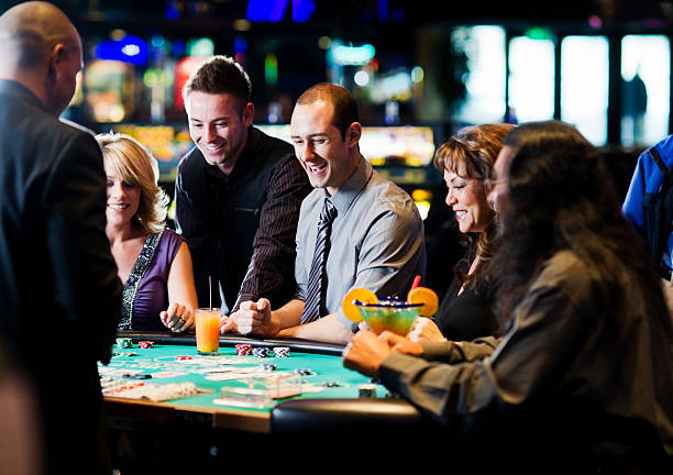 Live dealer rolling three dice in transparent shaker